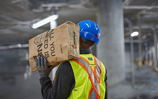 worker carrying large Mondi bag