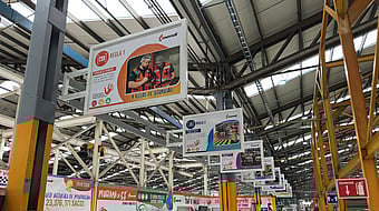 Marketing billboard display suspended from the ceiling inside a Mondi warehouse.