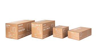 Four brown corrugated cardboard product packaging boxes of different sizes displayed in a row against a light grey background. The boxes feature white technical line drawings, product names, and specifications printed on the sides, showcasing a range of compact water heater packaging designs.